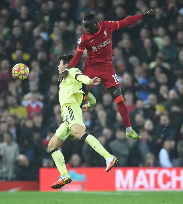 Framed Print : Liverpool vs. Arsenal: Intense Clash as Tomiyasu Fouls Mane