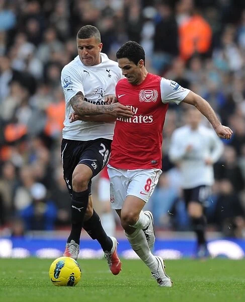 LONDON, ENGLAND - FEBRUARY 26: Mikel Arteta of Arsenal challenged by Kyle Walker of Tottenham during the Barclays Premier League match between Arsenal and Tottenham Hotspur at Emirates Stadium on February 26, 2012 in London, England. (Photo by Stuart MacFarlane  /  Arsenal FC via