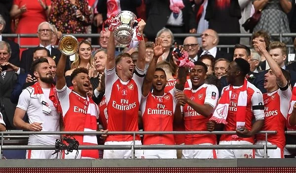 LONDON, ENGLAND - MAY 27: Rob Holding of Arsenal lifts the FA Cup Trophy after the match between Arsenal