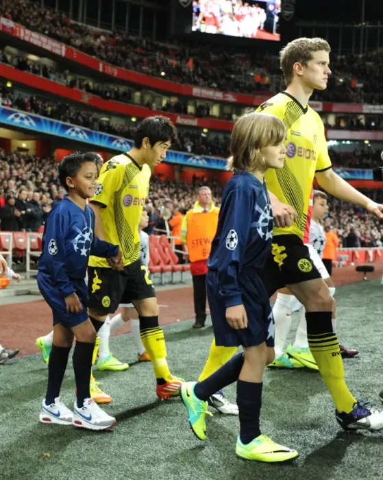Framed Print : LONDON, ENGLAND - NOVEMBER 23: Player escorts before the UEFA Champions League Group F match between Arsenal FC and Borussia Dortmund at Emirates Stadium on November 23, 2011 in London, England. (Photo by David Price / Arsenal FC via Framed Print : LONDON, ENGLAND - NOVEMBER 23: Player escorts before the UEFA Champions League Group F match between Arsenal FC and Borussia Dortmund at Emirates Stadium on November 23, 2011 in London, England. (Photo by David Price / Arsenal FC via