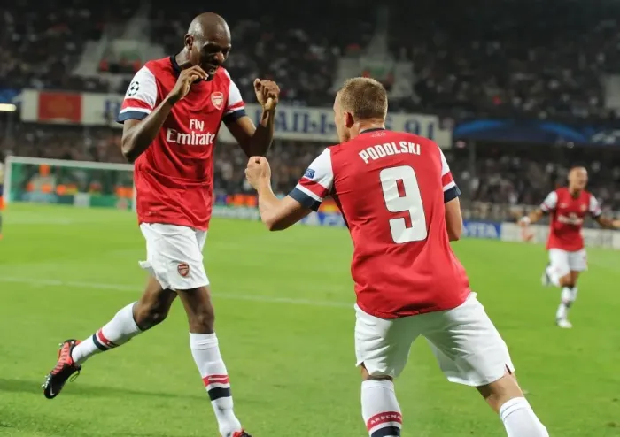 Framed Print : Lukas Podolski and Abou Diaby Celebrate Arsenal's First Goal Against Montpellier (2012-13)