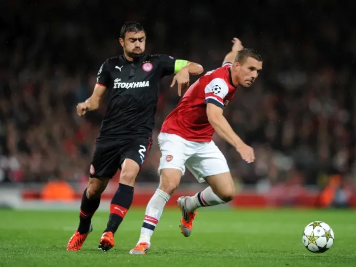 Framed Print : Lukas Podolski (Arsenal) Giannis Maniatis (Olympiacos). Arsenal 3: 1 Olympiacos