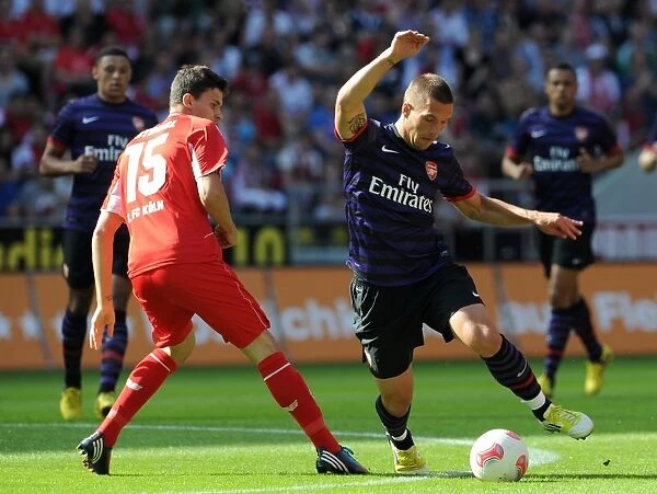Lukas Podolski (Arsenal) Tobias Strobl (Cologne). Cologne 0: 4 Arsenal. Pre Season Friendly