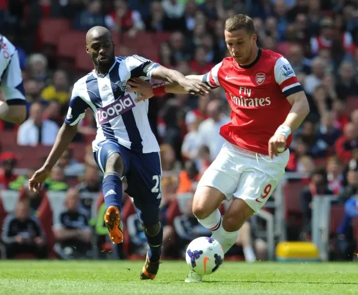 Framed Print : Lukas Podolski (Arsenal) Yousouf Mulumbu (WBA). Arsenal 1: 0 West Bromwich Albion