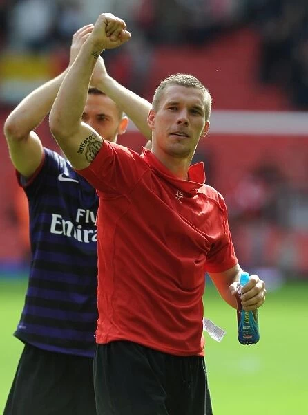 Lukas Podolski Celebrates with Arsenal Fans: Liverpool vs Arsenal, Premier League 2012-13