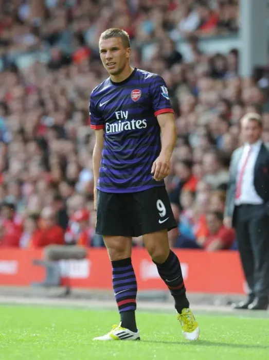 Framed Print : Lukas Podolski Faces Off Against Liverpool in the 2012-13 Premier League