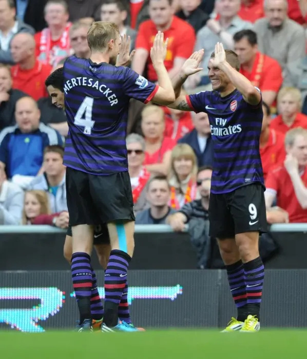 Framed Print : Lukas Podolski and Per Mertesacker Celebrate First Arsenal Goal Against Liverpool (2012-13) Framed Print : Lukas Podolski and Per Mertesacker Celebrate First Arsenal Goal Against Liverpool (2012-13)