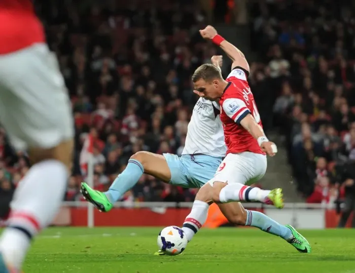 Framed Print : Lukas Podolski scores his and Arsenals 1st goal under pressure from Winston Reid (West Ham) Framed Print : Lukas Podolski scores his and Arsenals 1st goal under pressure from Winston Reid (West Ham)