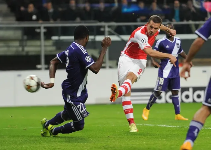 Framed Print : Lukas Podolski Scores Against Chancel Mbemba: Arsenal's Victory in the UEFA Champions League against RSC Anderlecht (2014)