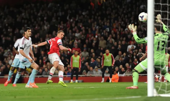 Framed Print : Lukas Podolski Scores Dramatic Goal Past James Tomkins and Adrian in Arsenal's Victory over West Ham United Framed Print : Lukas Podolski Scores Dramatic Goal Past James Tomkins and Adrian in Arsenal's Victory over West Ham United