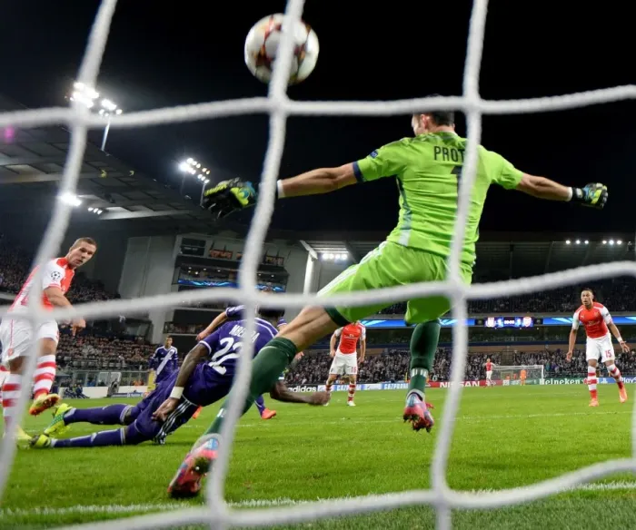 Framed Print : Lukas Podolski Scores Against Silvio Proto: Arsenal's Victory in Anderlecht (Champions League 2014-15) Framed Print : Lukas Podolski Scores Against Silvio Proto: Arsenal's Victory in Anderlecht (Champions League 2014-15)