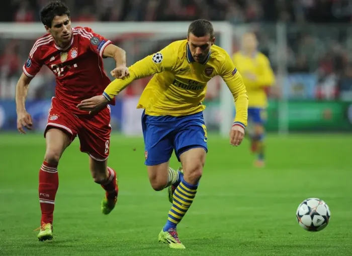 Framed Print : Lukas Podolski vs. Javi Martinez: Battle in the UEFA Champions League between FC Bayern Munich and Arsenal