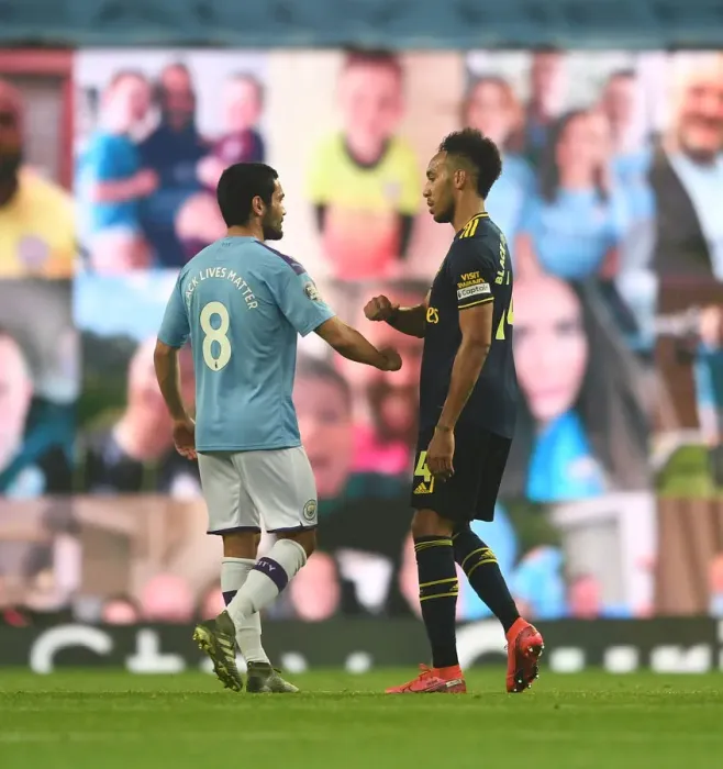 Framed Print : Manchester Rivalry: Aubameyang and Gundogan Embrace After Thrilling Manchester City vs. Arsenal Clash (Premier League 2019-20)