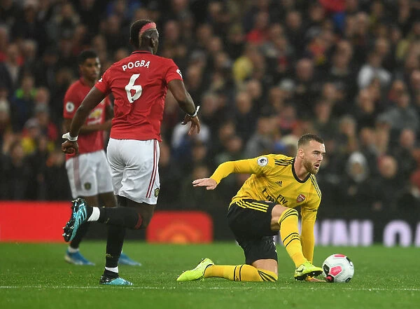 Manchester United vs Arsenal: Tense Moment as Calum Chambers Faces Off Against Paul Pogba in the Premier League
