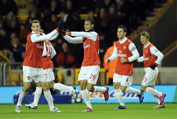 Marouane Chamakh celebrates scoring his and Arsenals 1st goal with Sebastien Squillaci