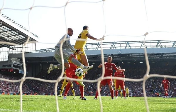 Marouane Chamakh jumps with Liverpool goalkeeper Pepe Reina. Liverpool 1: 1 Arsenal