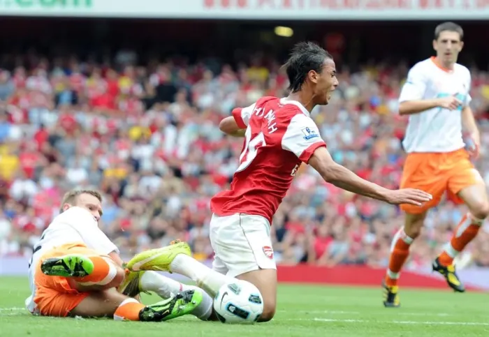 Framed Print : Marouane Chamakh is tripped by Blackpool defender Ian Evatt for the Arsenal penalty
