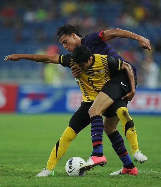 Marouane Chamakh vs Mohd Umar: Clash in the Malaysian Pre-Season Friendly between Arsenal and Malaysia XI