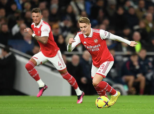 Martin Odegaard in Action: A Riveting Moment from the Arsenal vs. Tottenham Premier League Clash, 2022-23