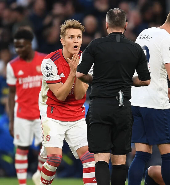 Martin Odegaard Appeals to Referee during Intense Tottenham vs. Arsenal Premier League Clash
