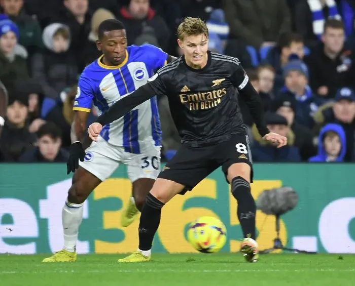 Framed Print : Martin Odegaard Breaks Past Brighton's Pervis Estupinan in Arsenal's Premier League Clash