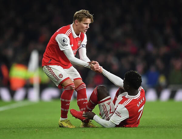 Martin Odegaard Consoles Bukayo Saka: A Heartwarming Moment of Sportsmanship Amidst Arsenal vs Manchester United Rivalry (2022-23)