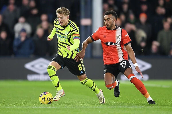 Martin Odegaard Faces Pressure from Jacob Brown in Luton Town vs Arsenal Premier League Clash (2023-24)