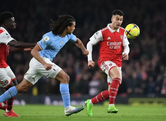 Framed Print : Martinelli vs Ake: A Fighting Spirit in Arsenal's Battle Against Manchester City