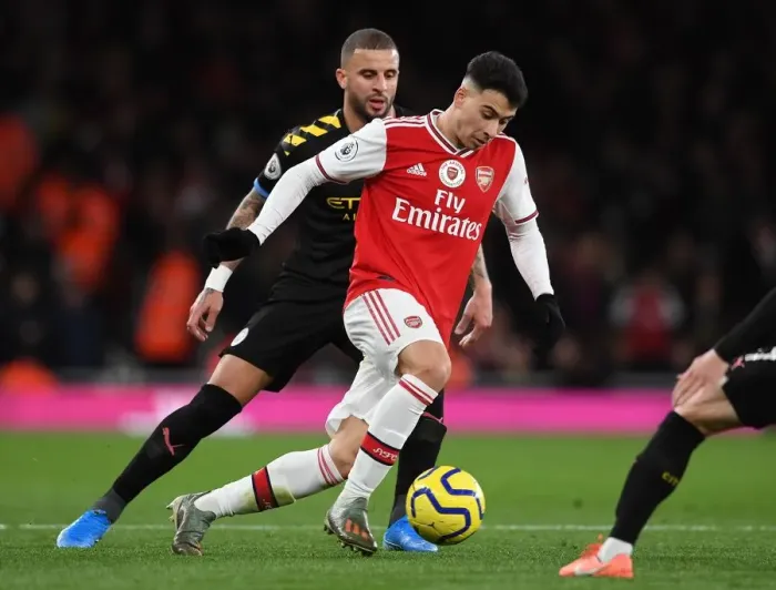 Framed Print : Martinelli vs. Walker: A Fiery Battle in Arsenal's Premier League Showdown against Manchester City