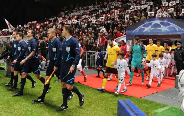 Framed Print : The match officials lead out the teams lead by Arsenal captain Cesc Fabregas