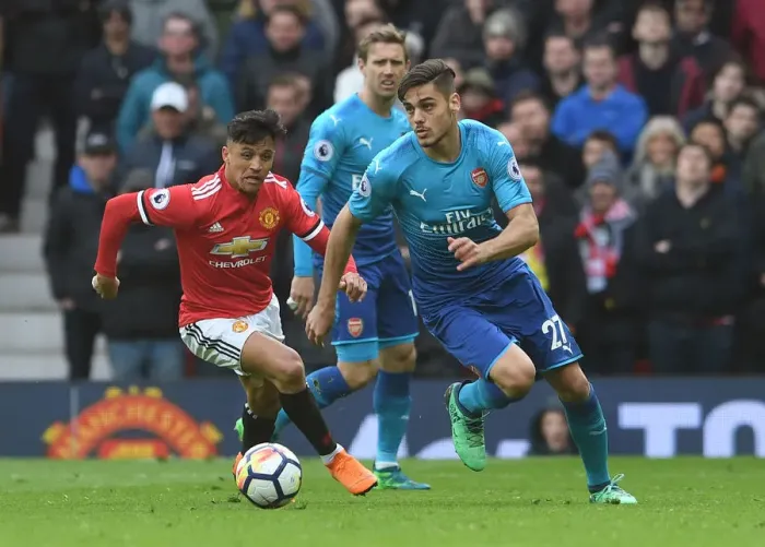 Framed Print : Mavropanos vs Sanchez: A Premier League Battle at Old Trafford Framed Print : Mavropanos vs Sanchez: A Premier League Battle at Old Trafford