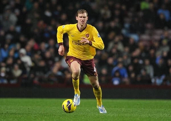 Per Mertesacker of Arsenal in Action against Aston Villa (2012-13 Premier League)