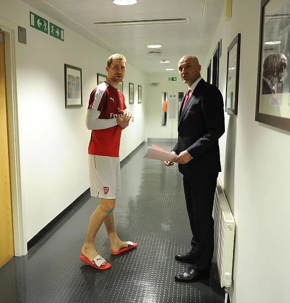 Per Mertesacker (Arsenal) with Assistant Manager Steve Bould before the match. Arsenal 0
