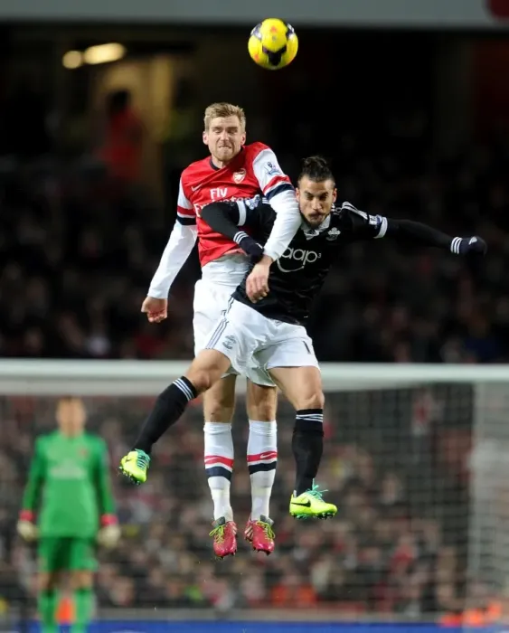 Framed Print : Per Mertesacker (Arsenal) Dani Osvaldo (Southampton). Arsenal 2: 0 Southampton. Barclays