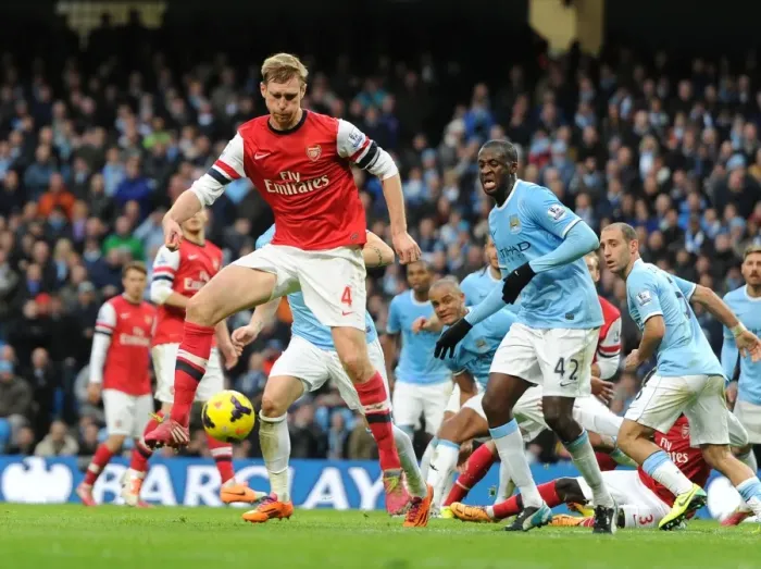 Framed Print : Per Mertesacker (Arsenal) Yaya Toure (Man City). Manchester City 6: 3 Arsenal. Barclays Framed Print : Per Mertesacker (Arsenal) Yaya Toure (Man City). Manchester City 6: 3 Arsenal. Barclays