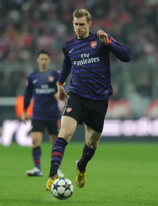 Framed Print : Per Mertesacker: Arsenal's Defiant Performance in Munich, UEFA Champions League 2012-13