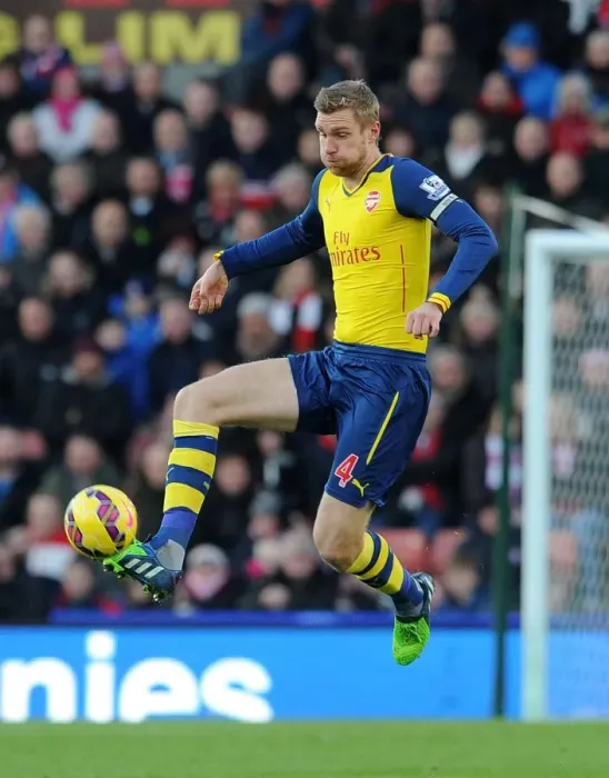 Framed Print : Per Mertesacker Focuses in Stoke City vs Arsenal Premier League Clash (2014-15)