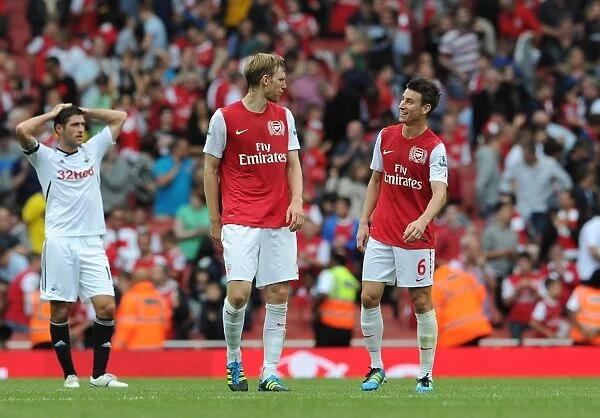 Per Mertesacker and Laurent Koscielny (Arsenal) chat after the match. Arsenal 1: 0 Swansea City