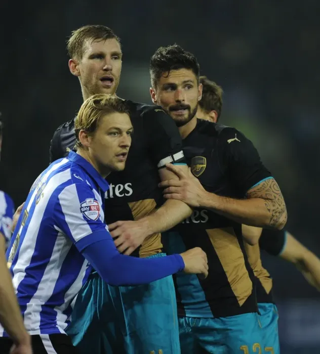 Framed Print : Per Mertesacker and Olivier Giroud vs. Glenn Loovens: A Capital One Cup Showdown