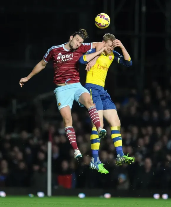 Framed Print : Per Mertesacker vs. Andy Carroll: Intense Clash in West Ham United vs. Arsenal Premier League Match Framed Print : Per Mertesacker vs. Andy Carroll: Intense Clash in West Ham United vs. Arsenal Premier League Match