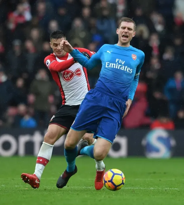 Framed Print : Per Mertesacker vs. Dusan Tadic: Intense Battle in Southampton v Arsenal Premier League Clash