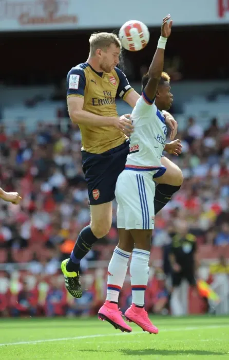 Framed Print : Mertesacker vs. N'Jie: A Tense Face-Off at Arsenal's Emirates Cup Framed Print : Mertesacker vs. N'Jie: A Tense Face-Off at Arsenal's Emirates Cup