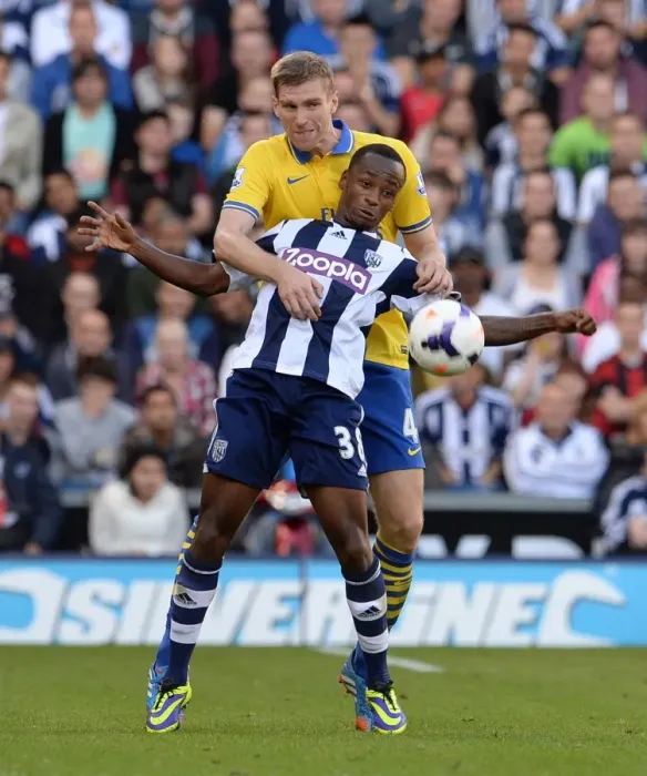 Framed Print : Per Mertesacker vs. Saido Berahino: A Battle in the Premier League (West Bromwich Albion vs. Arsenal, 2013) Framed Print : Per Mertesacker vs. Saido Berahino: A Battle in the Premier League (West Bromwich Albion vs. Arsenal, 2013)