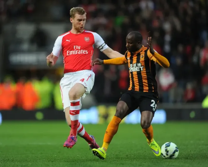 Framed Print : Per Mertesacker vs. Sone Aluko: Intense Tackle in Arsenal's Victory over Hull City, Premier League 2014 / 15