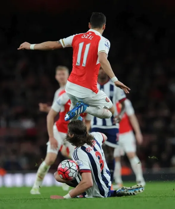 Framed Print : Mesut Ozil (Arsenal) Jonas Olsson (WBA). Arsenal 2: 0 West Bromwich Albion