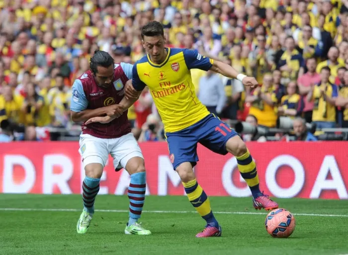 Framed Print : Mesut Ozil (Arsenal) Kieran Richardson (Villa). Arsenal 4: 0 Aston Villa. FA Cup Final Framed Print : Mesut Ozil (Arsenal) Kieran Richardson (Villa). Arsenal 4: 0 Aston Villa. FA Cup Final