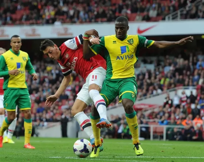 Framed Print : Mesut Ozil (Arsenal) Sebatien Bassong (Norwich). Arsenal 4: 1 Norwich City. Barclays Premier League Framed Print : Mesut Ozil (Arsenal) Sebatien Bassong (Norwich). Arsenal 4: 1 Norwich City. Barclays Premier League