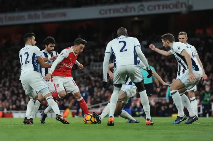Framed Print : Mesut Ozil (Arsenal) takes on Nacer Chadli and Claudio Yacob (WBA) Framed Print : Mesut Ozil (Arsenal) takes on Nacer Chadli and Claudio Yacob (WBA)