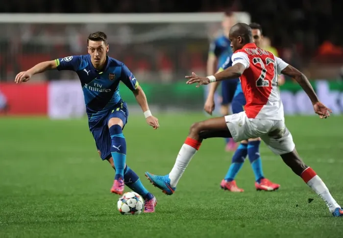 Framed Print : Mesut Ozil Breaks Past Monaco's Geoffrey Kondogbia: Arsenal vs Monaco, UEFA Champions League Round of 16, March 2015