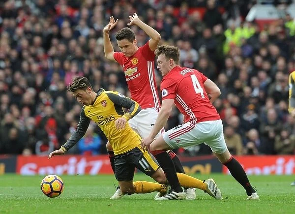 Mesut Ozil Clashes with Manchester United's Ander Herrera and Phil Jones during the Intense 2016-17 Premier League Match